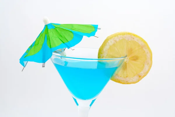 Detail of blue cocktail with lemon and umbrella — Stock Photo, Image