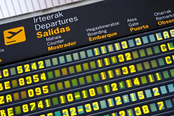 Departures board at airport — Stock Photo, Image