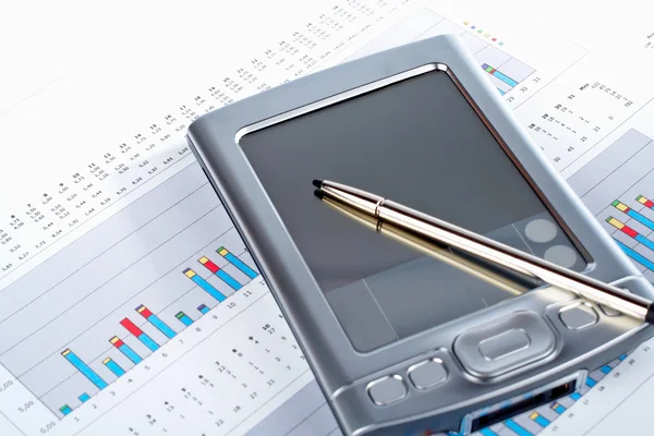 PDA on market financial chart background — Stock Photo, Image