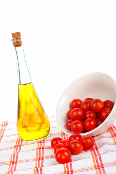 Olive oil bottle and tomatos cherry — Stock Photo, Image