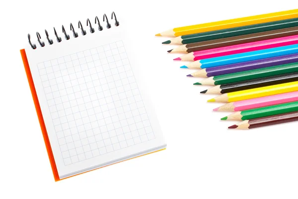 Blank notebook and coloured pencils Stock Image