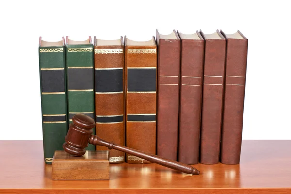 Wooden gavel and old law books Stock Picture