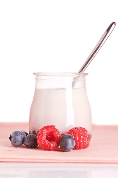 Yogurt and fresh raspberries and blueberries Royalty Free Stock Images