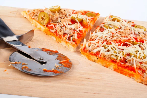 Detail of slices Italian pizza and cutter Royalty Free Stock Images