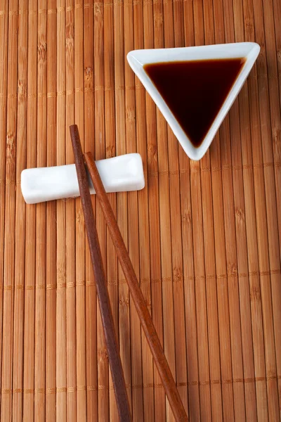 A pair of asian chopsticks and soy sauce Royalty Free Stock Photos