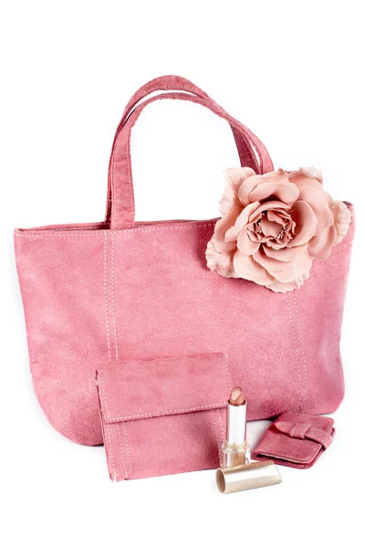 Asortyment różowe torebki i szminka Obrazy Stockowe bez tantiem