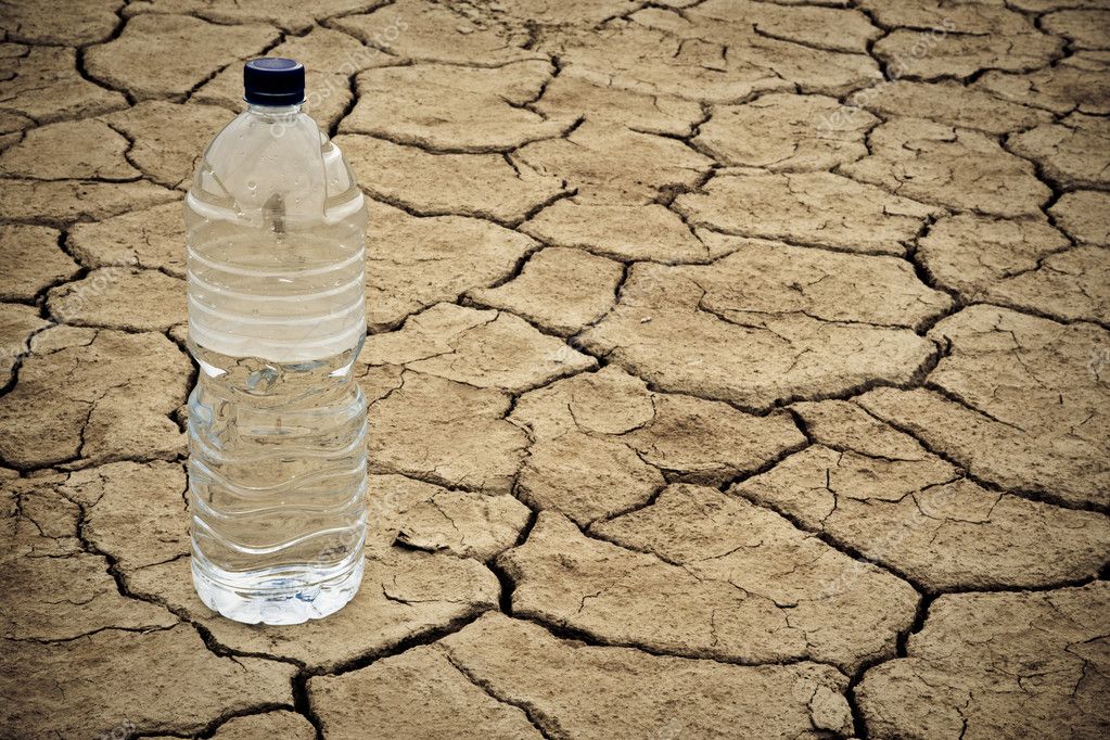 Water bottle on dry ground — Stock Photo © broker 6345796