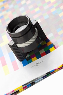 Loupe over a printer's proof clipart