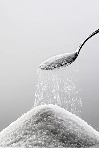 Sugar and a spoon — Stock Photo, Image