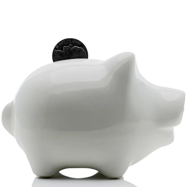 Piggy bank on white with dime — Stock Photo, Image