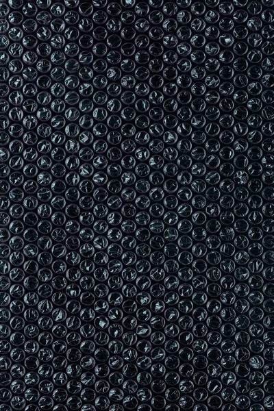 Bubbelplast på svart — Stockfoto
