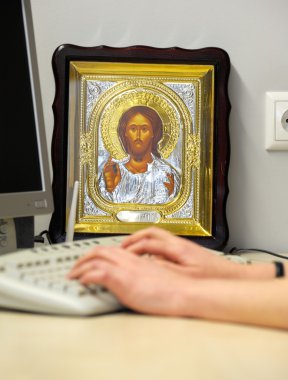 Religious icons in a modern office clipart