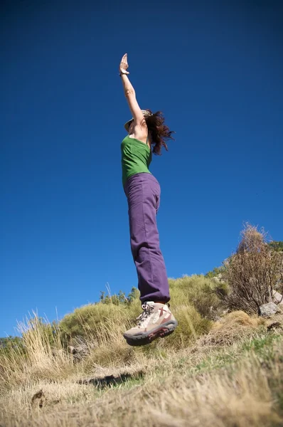 Female with cap jumping — Stock Photo, Image