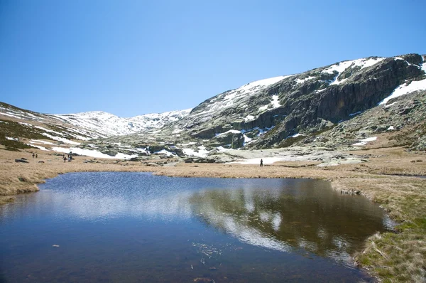 Велике озеро спускається сніговою горою — стокове фото