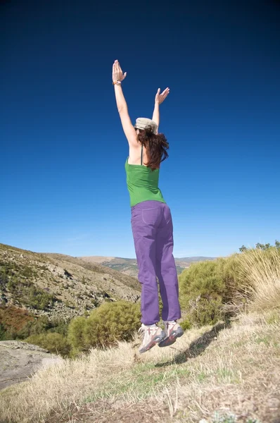 Jumping female with cap — Stock Photo, Image