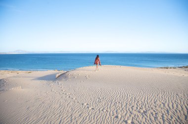 Hiking on tarifa sand dunes clipart