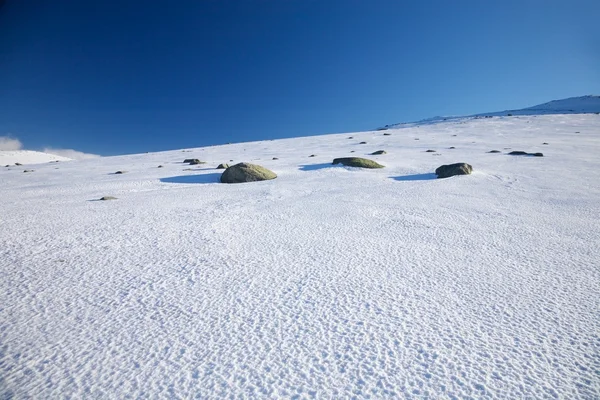 Three rocks on snow — Stock Photo, Image