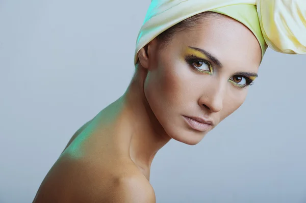 Beautiful woman in yellow scarf on her head and bright makeup — Stock Photo, Image