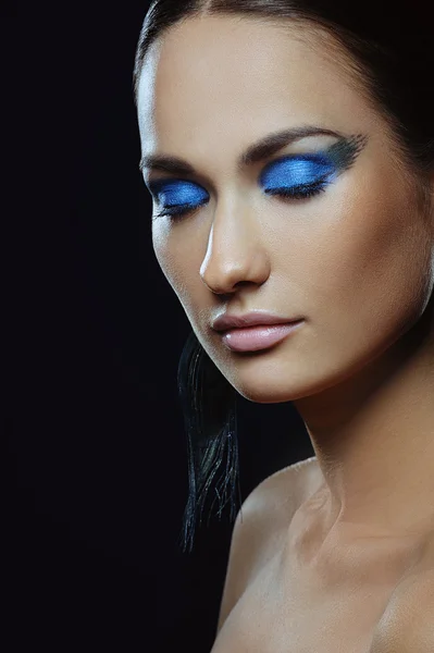 Beautiful girl with blue make-up in long earrings — Stock Photo, Image