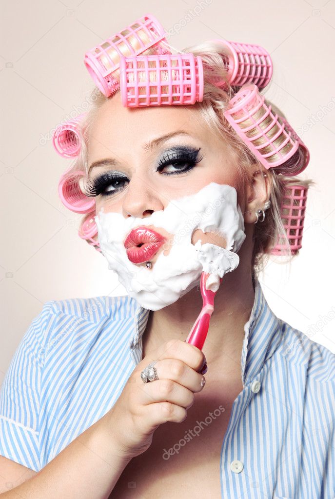 Attractive girl is shaving face