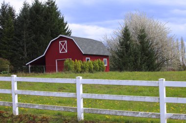 A red barn in a countryside. clipart