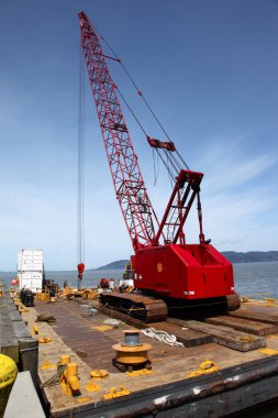 Heavy duty crane on a barge, port of Astoria OR. clipart