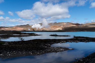 Blue lagoon in front of a geothermal powerplant clipart