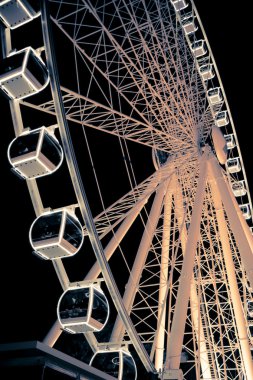 Ferris Wheel glowing at night clipart