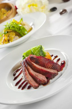 Oven crisp duck breast marinated in a Peking duck style sauce on clipart