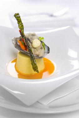 Oysters Kilpatrick served on designer plate in restaurant clipart