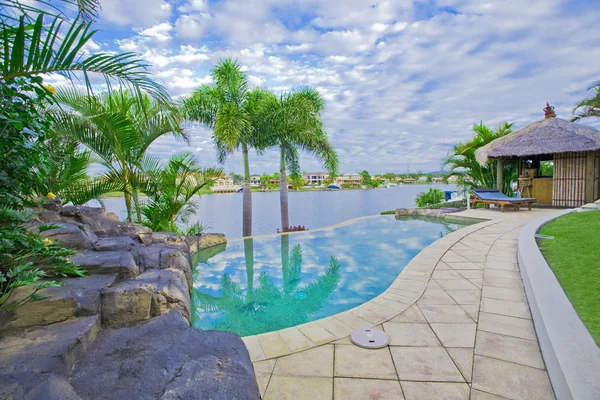 Palazzo sul lungomare con piscina e capanna Bali con vista sul canale — Foto Stock