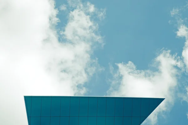 La parte superior del moderno edificio de vidrio corporativo con cielo y nubes —  Fotos de Stock