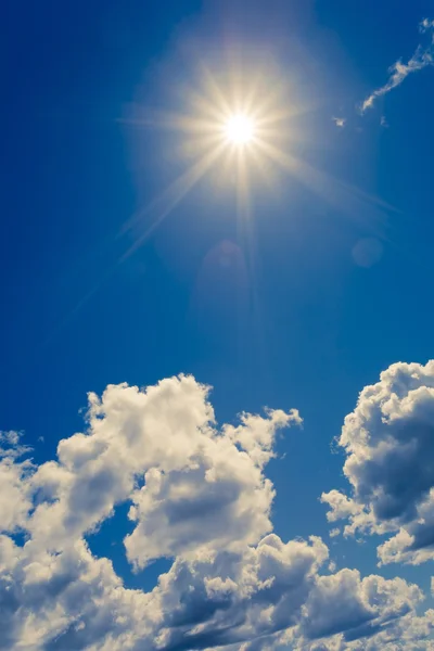Bright sun on blue sky with clouds — Stock Photo, Image