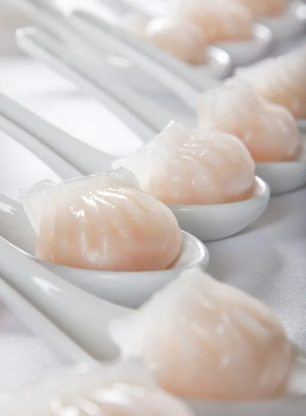 Dumplings served on white spoons — Stock Photo, Image