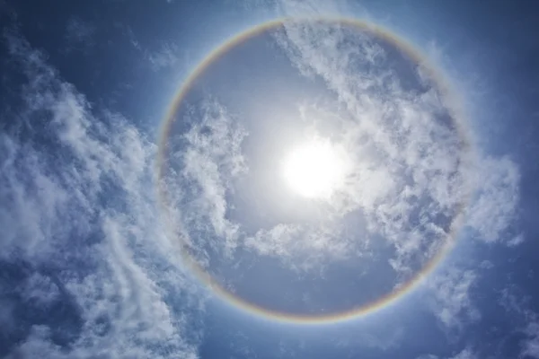 Sun with sircular rainbow and clouds — Stock Photo, Image