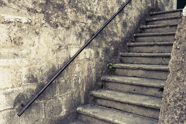 Nice old outdoor staircase Croatia. Image is cross processed to reflect age and time.