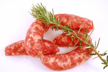 Set sausages ready to be cooked with rosemary clipart