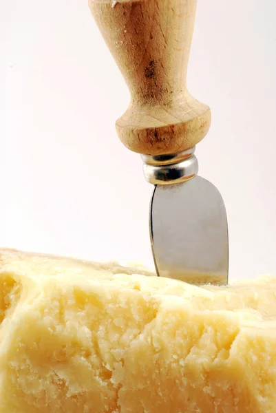 Still life of piece of parmesan cheese with knife — Stock Photo, Image