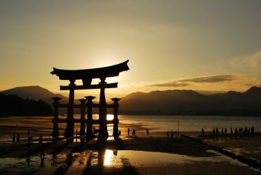 Torii gate of a temple during sunset clipart