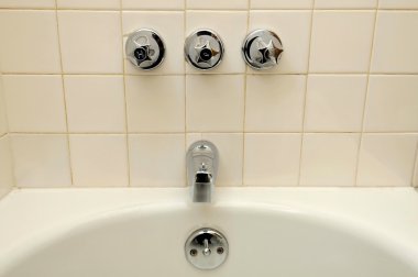 Front view of bathtub and water taps clipart