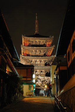 Night shot of five storied pagoda along an ancient street clipart
