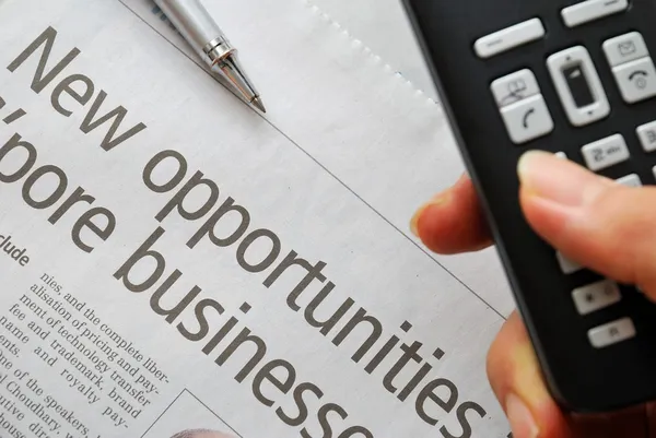 Closeup on new opportunities text and hand phone — Stock Photo, Image