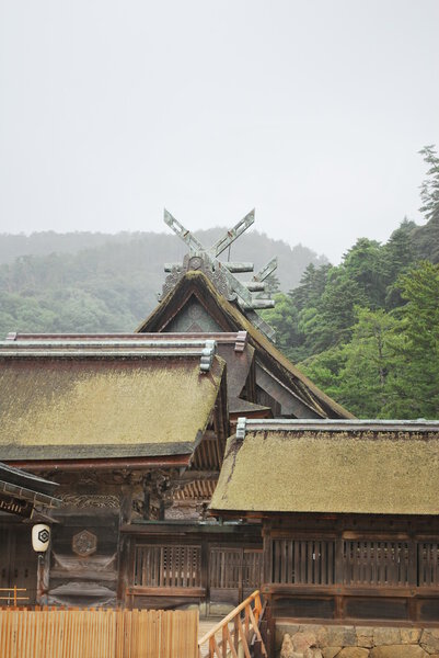 Ancient shrine architecture in the heavy rain. Known as Izumo Taisha shrine. Taken in Shimane, Japan. A symbol of history, religion, faith, respect and worship.