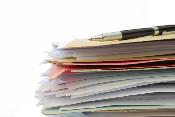 Pen on stack of files full of documents — Stock Photo, Image
