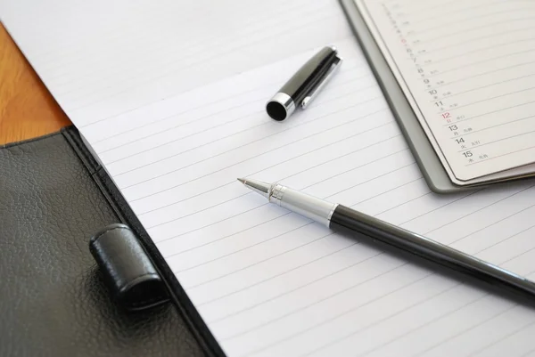 Black pen on blank writing pad