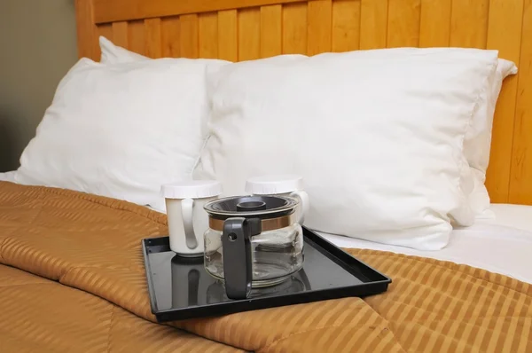 Кофе или чайник на кровати — стоковое фото