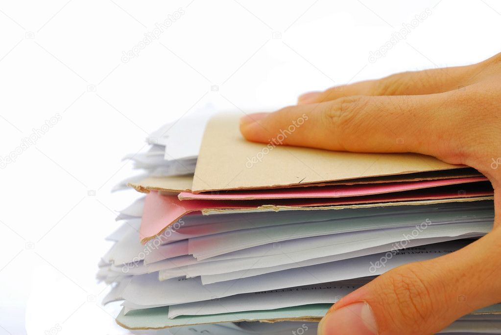 Hand holding stack of files