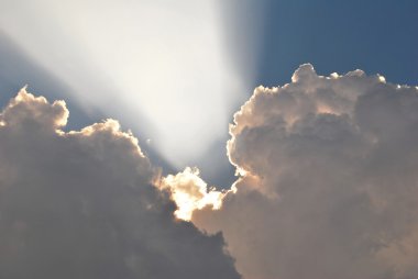 Sun rays penetrating the clouds clipart