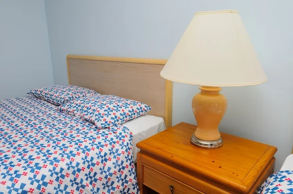 Односпальная кровать с лампой — стоковое фото