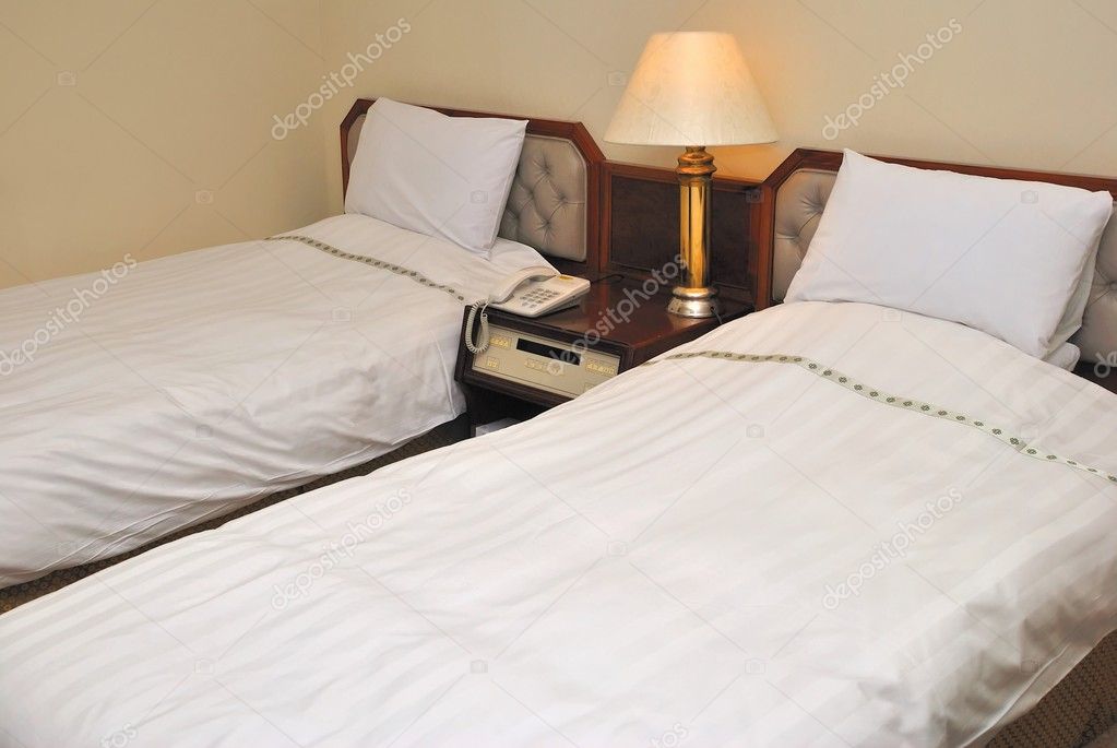 Twin beds in modern hotel room